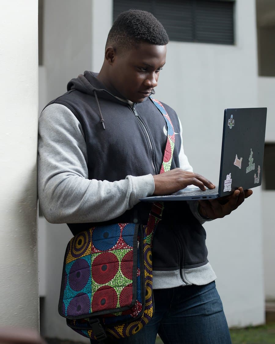 Student working on a laptop outside a hostel