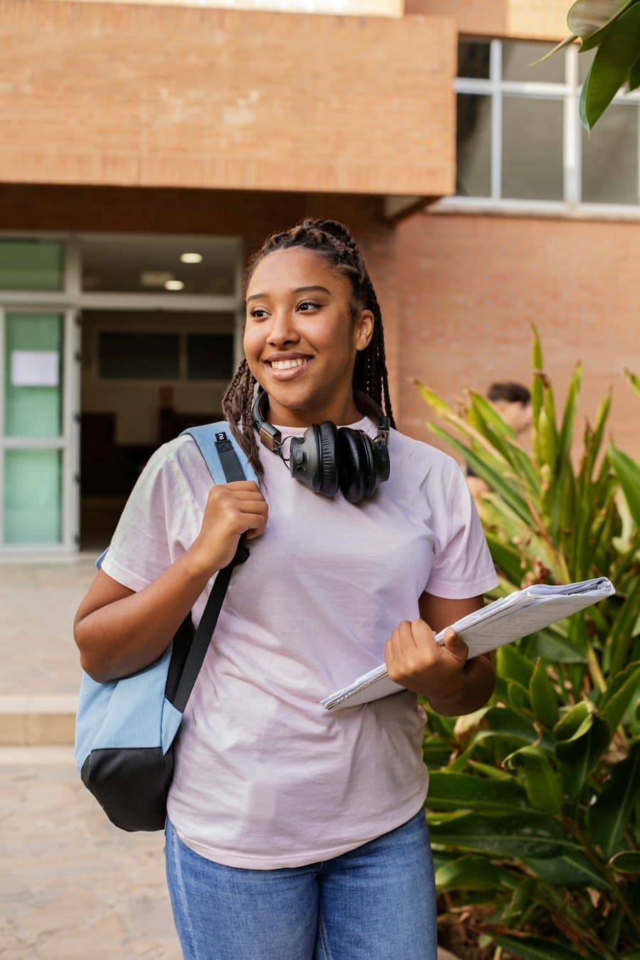 Smiling student with a backpack on the way to class